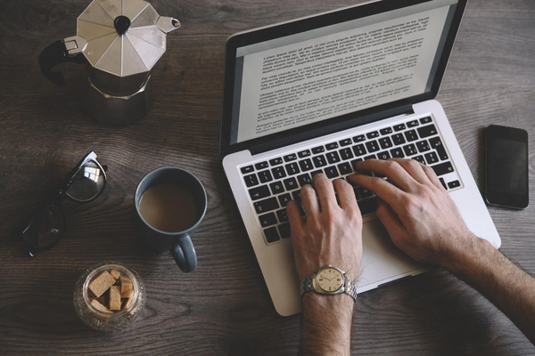 Open notebook with a pen on a wooden table